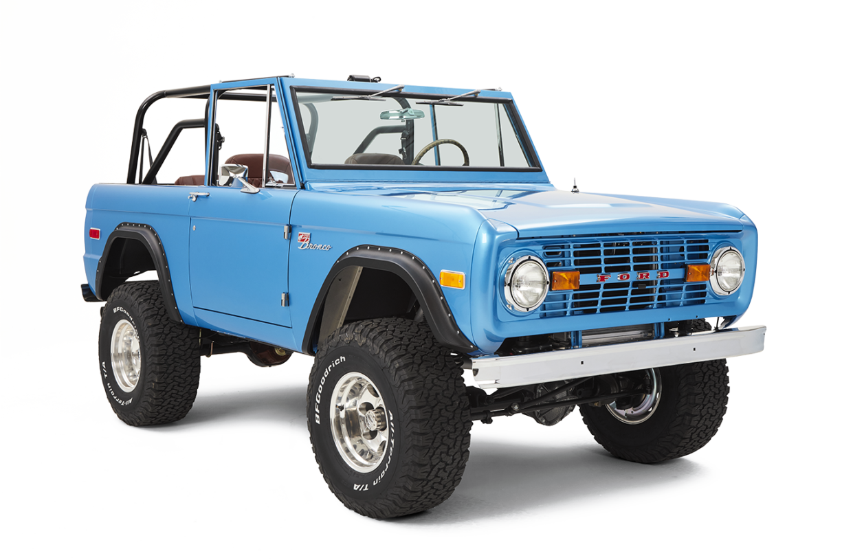 A vintage blue off-road SUV with large tires and a removable roof.