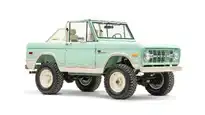 Classic mint green off-road vintage SUV with rugged tires.